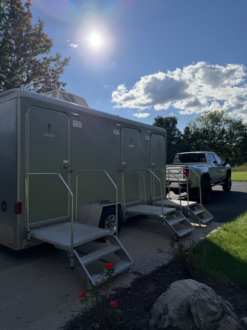 Restroom trailer exterior with truck