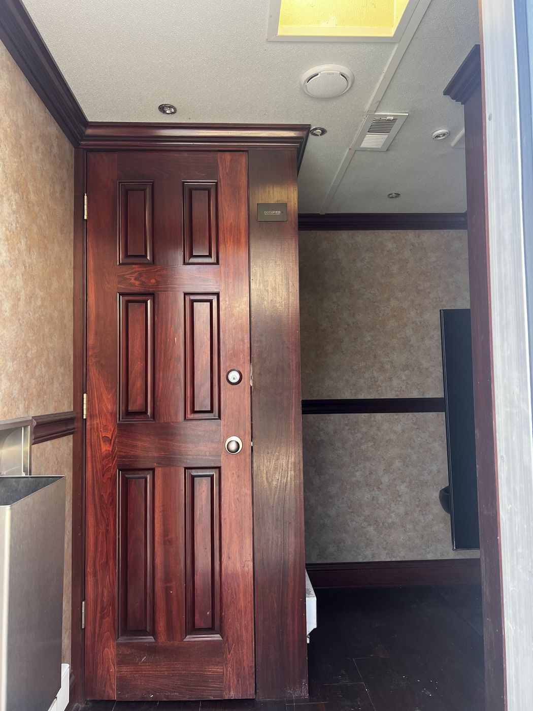 Private stall interior with occupied sign